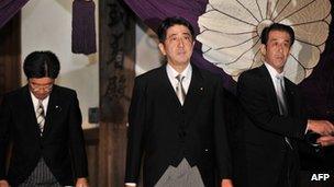 Shinzo Abe (C), leaving the controversial Yasukuni Shrine in Tokyo, 17 October 2012