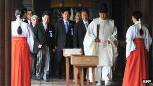 A Shinto priest leads a group of Japanese lawmakers during a visit to the controversial Yasukuni Shrine in Tokyo on 18 October 2012