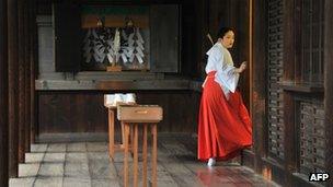 A maiden setting up a reception for visiting Japanese officials at the controversial Yasukuni Shrine in Tokyo, 18 October 2012