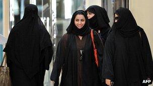 Saudi women walk inside the Faysalia mall in Riyadh City, on September 26, 2011,
