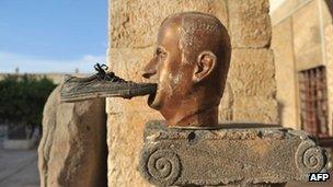 A shoe is seen glued to a statue of late Syrian president Hafez al-Assad, at the museum of Maaret al-Numan, in the north-western Idlib province, 17 October 2012