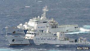 A Chinese marine surveillance ship cruises next to a Japan Coast Guard patrol ship in the East China Sea, file pic from 24 September 2012