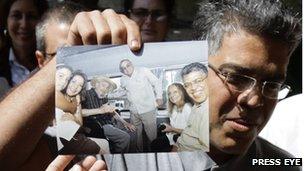 Elias Jaua shows a picture of his meeting with Fidel Castro