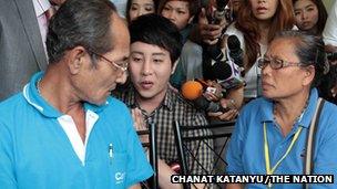 Thanat "Dr Pop" Natveerakul (centre) apologises to the parents of Kratae Eiamyai at a Bangkok police station.