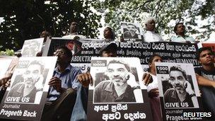 Demonstrators hold placards with an image of missing cartoonist and columnist Prageeth Eknaligoda, during a protest in front of the United Nations head office in Colombo