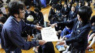 A Japanese girl getting her graduation certificate