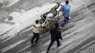 Residents wheel an injured man to hospital in Aleppo, 23 October 2012