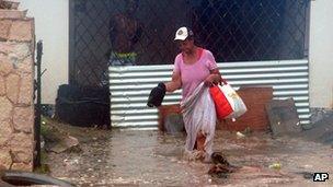 Woman walks through floodwater in Kingston, Jamaica (24 Oct 2012)