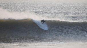 A surfer on the Glamorgan Heritage Coast
