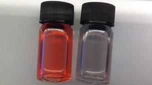 Two vials showing the test results