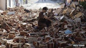 Man salvages bricks in Santiago after Hurricane Sandy hit - 27 October