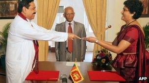 This handout photo taken on May 18, 2011 and released by Sri Lanka"s Presidential Secretariat shows President Mahinda Rajapakse (L) presenting a letter of appointment to Shirani Bandaranayake who became Sri Lanka"s first woman chief justice.