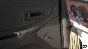A window handle on the door at the back seat has been removed from a Beijing taxi, 1 Nov 2012