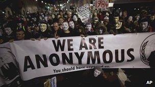 Masked protesters march to Parliament