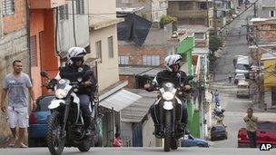 Motorcycle policemen patrol the Paraisopolis slum in Sao Paulo, Brazil, on 2/11/12
