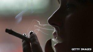 Person smoking a cannabis cigarette