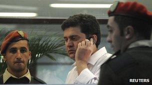 Former Georgian Interior Minister Bacho Akhalaia (C) speaks on his mobile inside the prosecutor's office in Tbilisi on 6 November