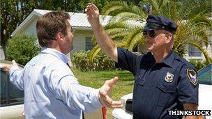 Stock photo of a police officer performing a field sobriety test