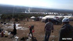 Syrian refugees are seen in a refugee camp on the Syrian side of the border with Turkey, near Idlib, on 15 November 2012