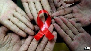 Chinese students show a handmade red ribbon at a school in Hanshan, east China's Anhui province, ahead of the 2009 World AIDS Day, 30 Nov 2009