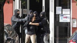 Izaskun Lesaka, centre, surrounded by French Police officers, screams as she leaves the hotel where she was arrested with another suspected member of Eta
