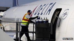 A Delta Airlines worker loads food onto a plane last week
