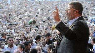 Egyptian President Mohammed Morsi speaks to supporters outside the presidential palace in Cairo