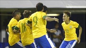 Brazil players celebrate a goal against Argentina
