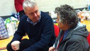 First Minister Carwyn Jones talks to a victim of the floods in St Asaph