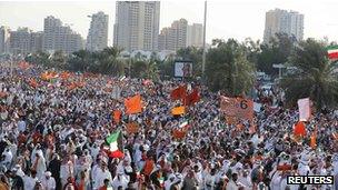 Kuwaiti opposition supporters wave flags during election protest in Kuwait City