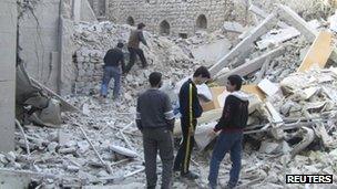 Photo allegedly showing residents looking at destroyed buildings in Homs, Syria. Photo: November 2012