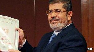 Mr Morsi receives a copy of the draft constitution, 1 Dec