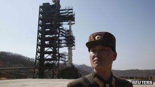 File photo: A soldier standing guard in front of a rocket sitting on a launch pad at the West Sea Satellite Launch Site, Pyongyang, 8 April 2012
