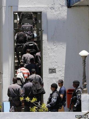 Arrested police officers arrive at their headquarters in Rio de Janeiro