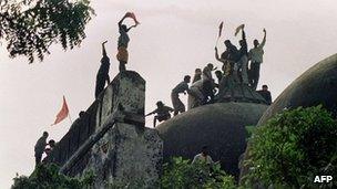 file photograph taken on December 6, 1992, Hindu youths clamour atop the 16th century Muslim Babri Mosque five hours before the structure was completely demolished by hundreds supporting Hindu fundamentalist activists in Ayodhya.