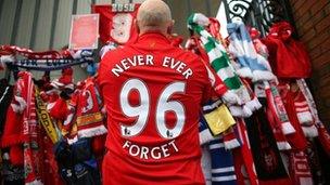Liverpool supporter pays his respects at the Hillsborough Memorial at Anfield