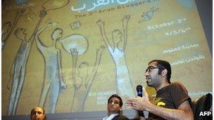 Saudi Arabian blogger Ahmed Al Omrane (right) speaks during the third Arab Bloggers Meeting on 3 October 2011, in Tunis.