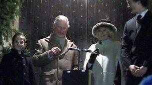 Prince Charles and his wife Camilla turn on the lights