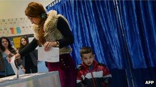 A Romanian casts her vote on Sunday