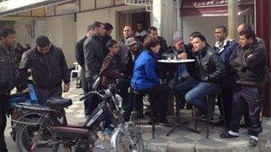 Lyse Doucet talking to people at a cafe in Siliana