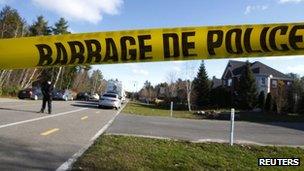 Police tape lines the road as Surete du Quebec officers investigate in Blainville, Quebec, 5 November 2012