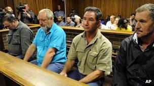 Four men appear in the dock on charges of treason and terrorism at the Bloemfontein Court, South Africa