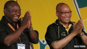 South Africa's President Jacob Zuma celebrates his re-election as party President alongside newly elected party Deputy President Cyril Ramaphosa (l) at the National Conference of the ruling African National Congress