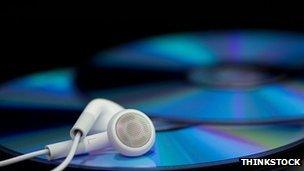 Stock image of earphones and CDs