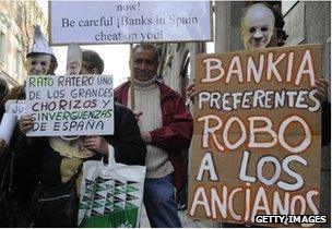 People hold placards reading "Bankia steal elderly people" and "Rato thief" during a demonstration against Bankia and former IMF chief Rodrigo Rato in front of Spain"s National Court in Madrid