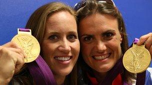 Helen Glover (L) and Heather Stanning with their Olympic gold medals