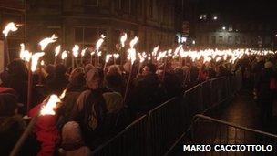 Crowds join torchlight procession