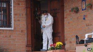 Forensic expert outside the house in Envigado