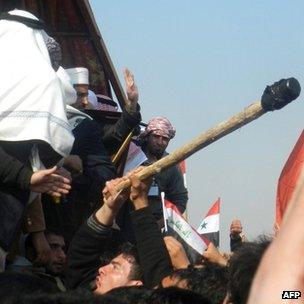 An Iraqi protesters attacks the stage where Iraq's deputy premier Saleh al-Mutlak arrived to give a speech on December 30