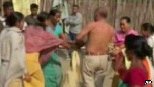 Video still of a politician being attacked by women in Assam state (3 Jan 2013)